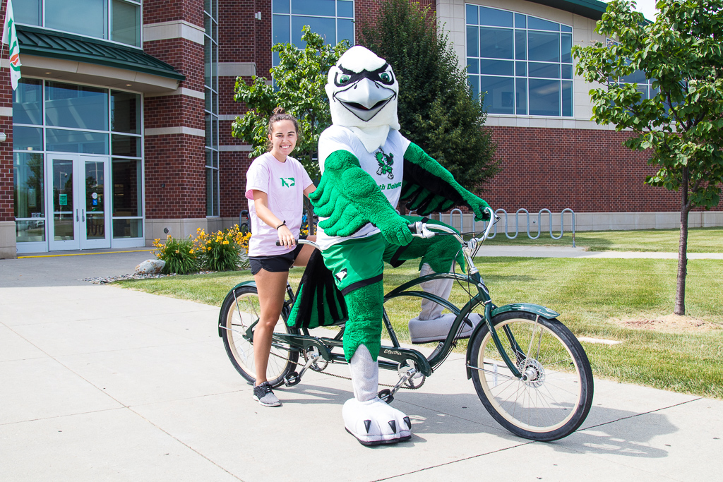 student biking with the Hawk