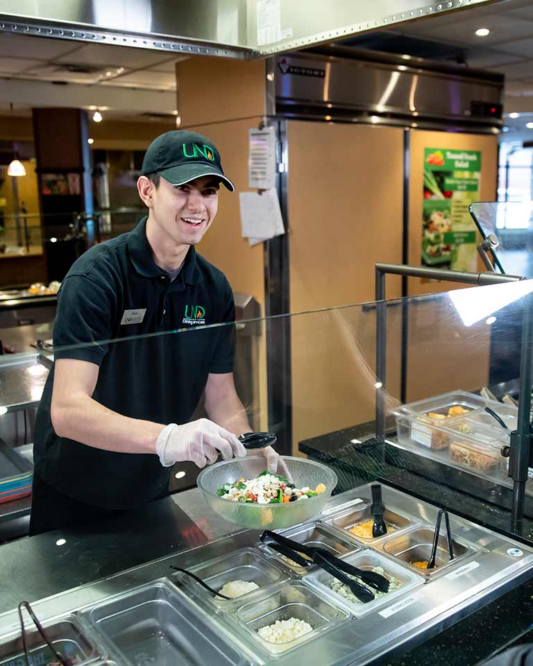 dining employee serving a student