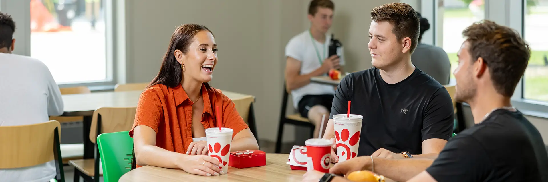 Students eating at a table in Memorial Union food court.
