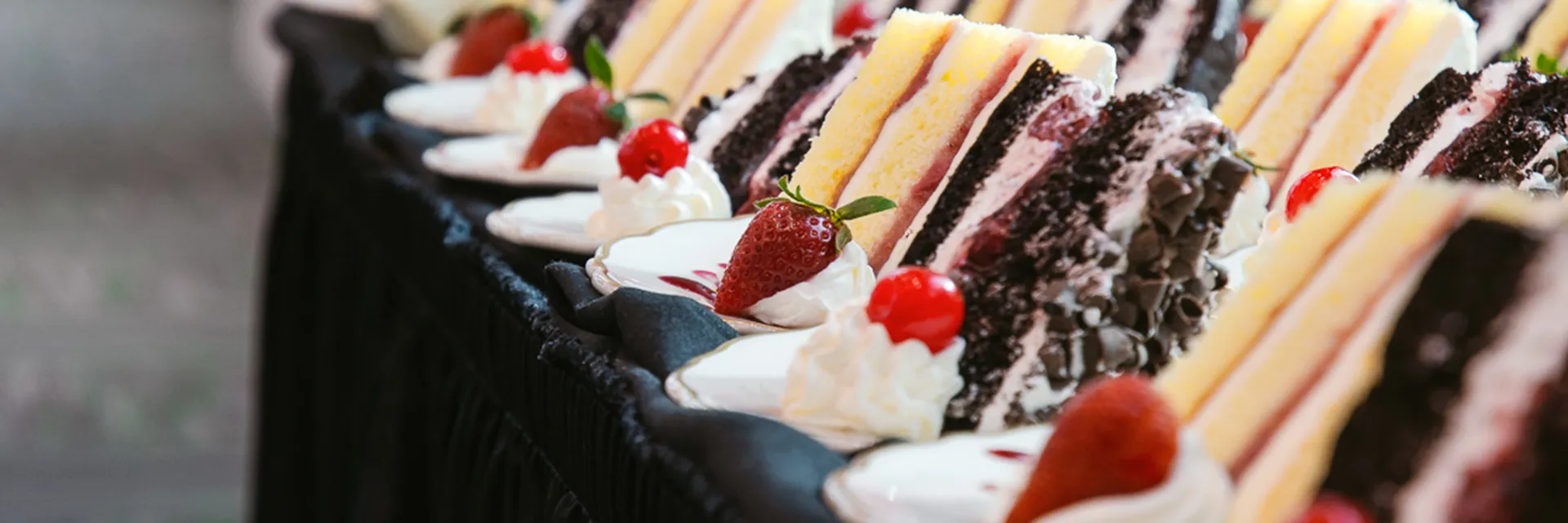 cake slices with fresh berries at catered event