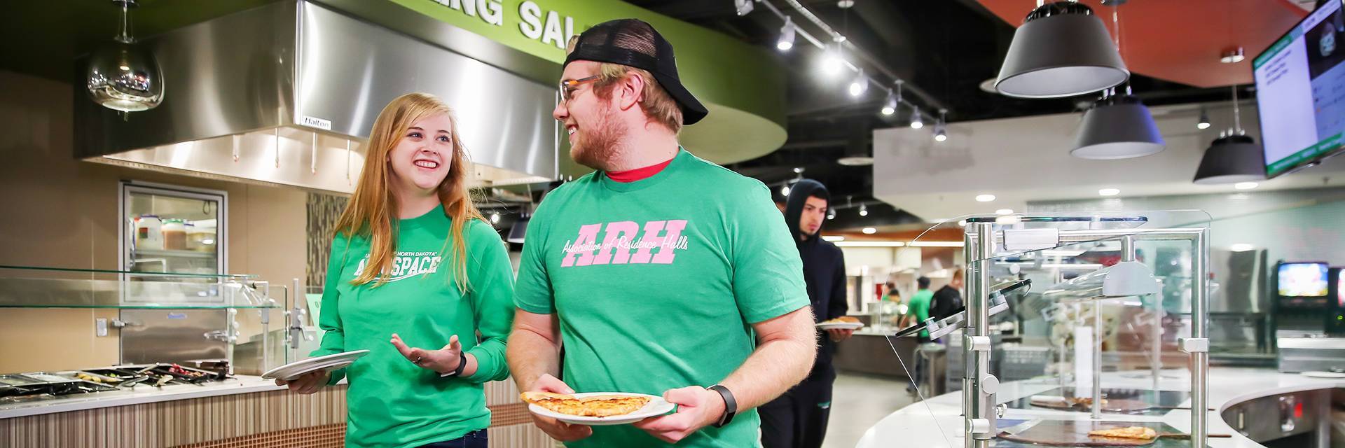 students walking in dining center with food