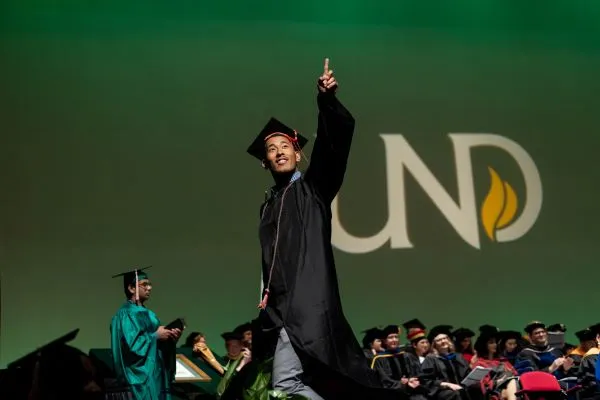 Student crossing stage at commencement