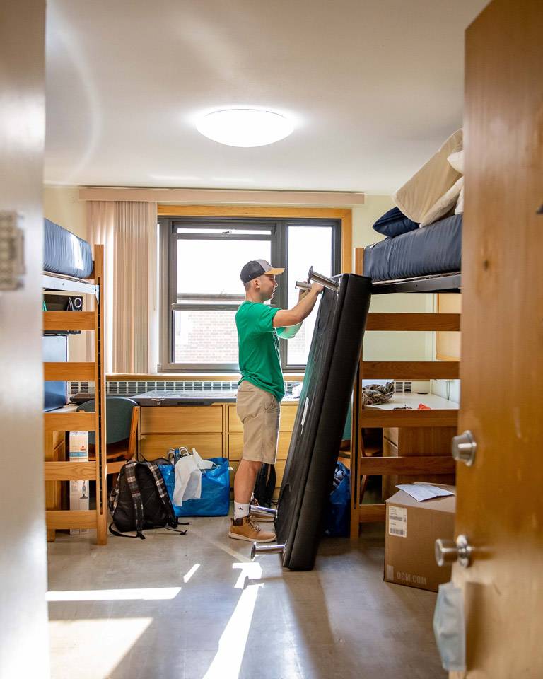 student stetting up futon in room