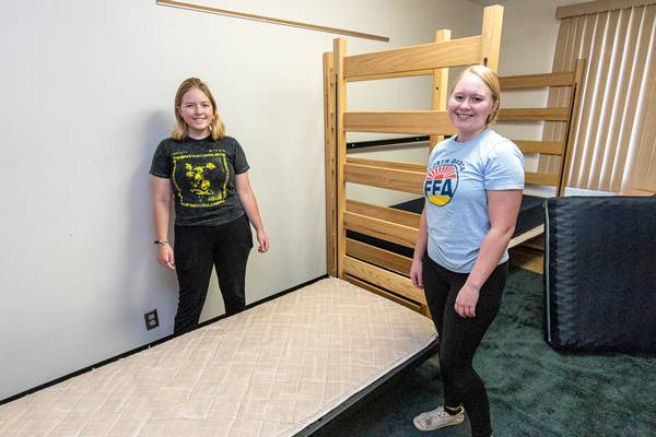 student lofting bed in residence hall room