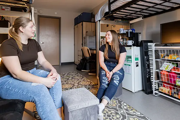 students talking in their residence hall room