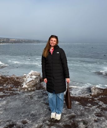Bella Hammer standing on a beach with a winter coat on