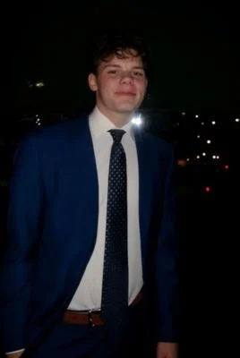 Aidan Schafer photo in a suit at night