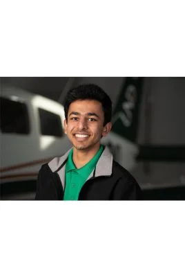 Ishir Agarwal in front of a plane