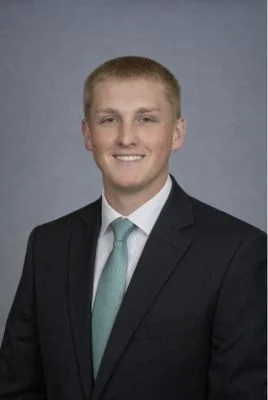 Jake Ring headshot in black suit