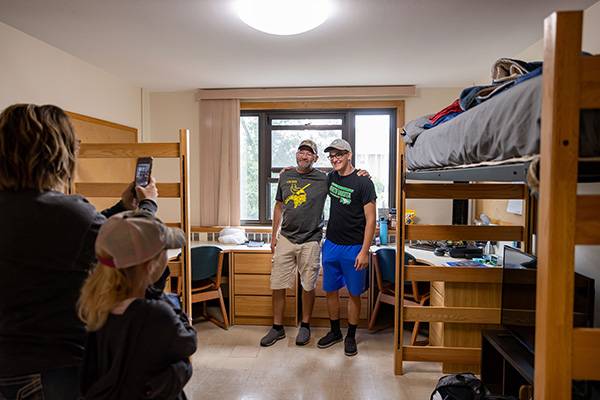 parents moving son into dorm room